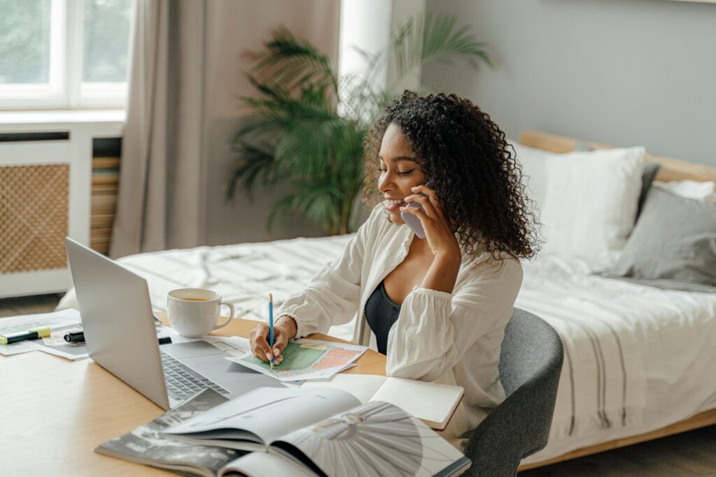 African American woman working beside her bed